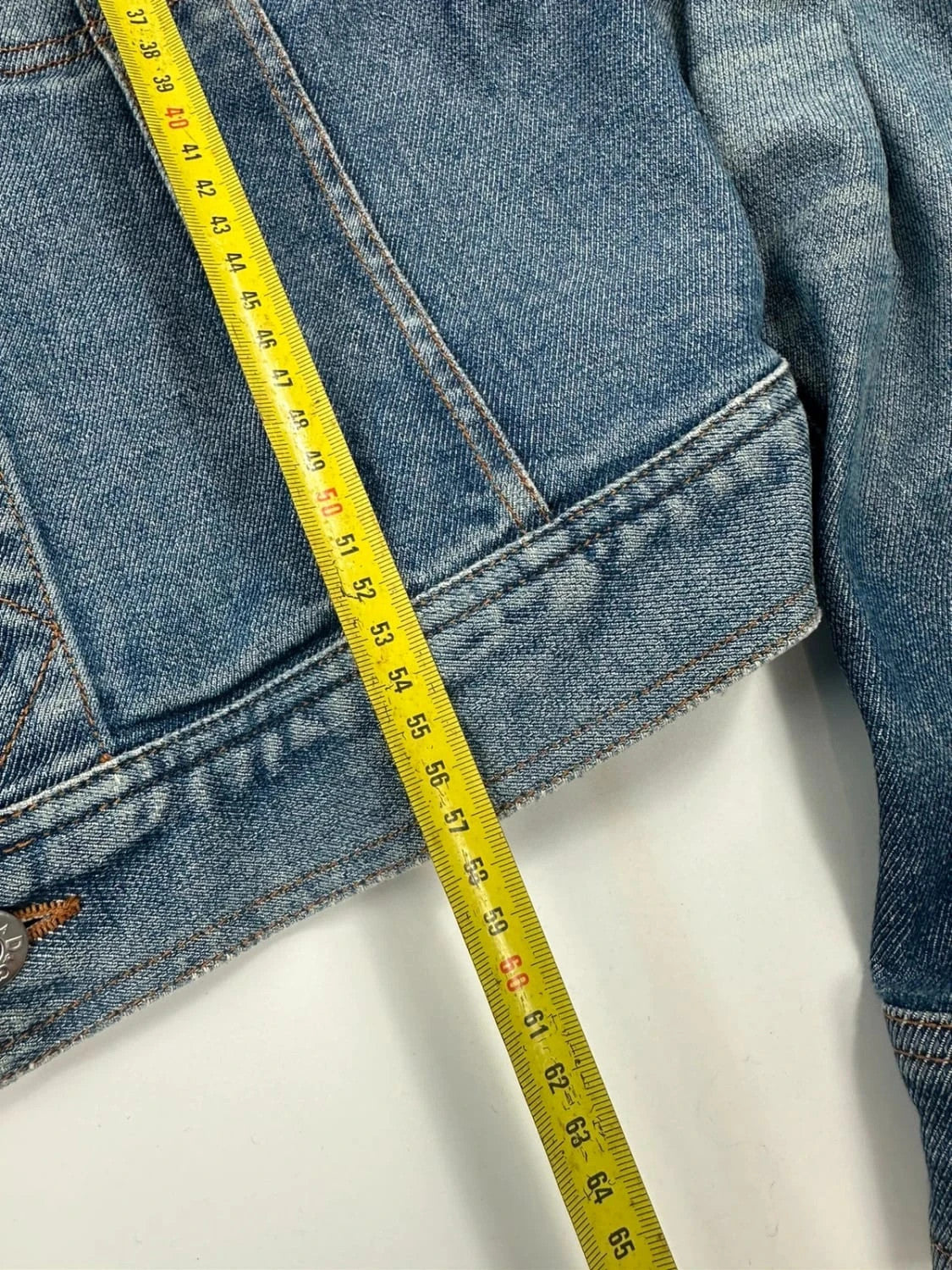 Dolce & Gabbana blue boxy crop denim jacket with logo detail and distressed finish.