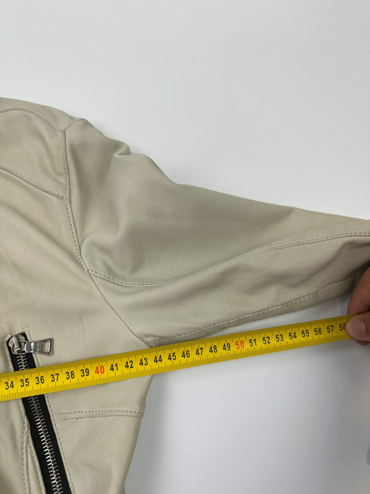 Prada beige leather fitted jacket with multi pockets and logo detailing.