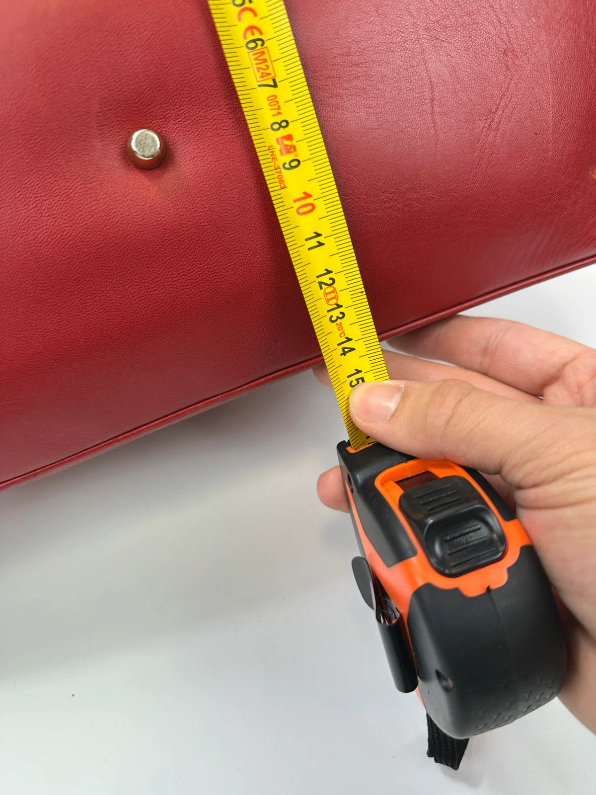 Prada red leather handbag with gold hardware and vintage logo detail.