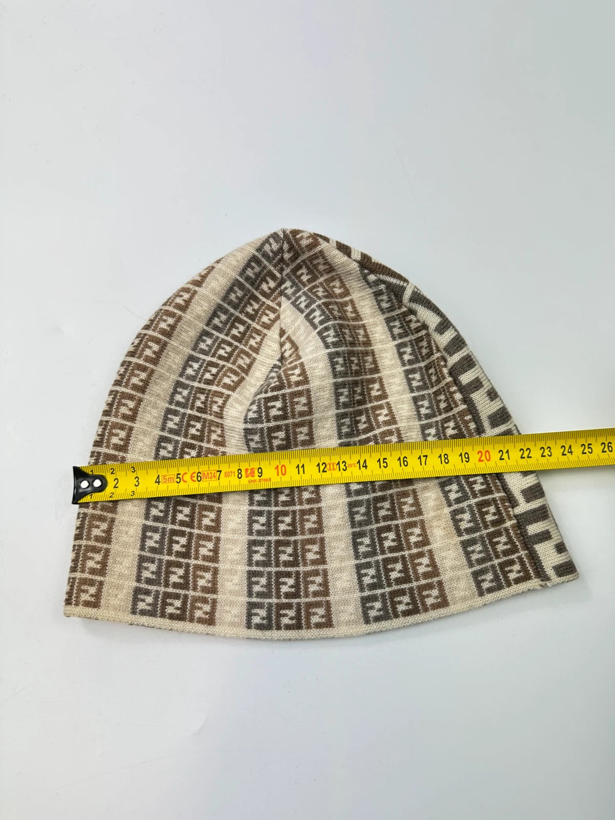 Fendi beige brown beanie featuring iconic monogram pattern and soft wool material.