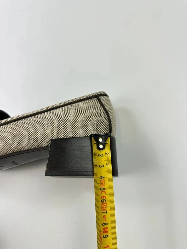 Prada grey and black leather loafers with linen upper and subtle logo detailing.