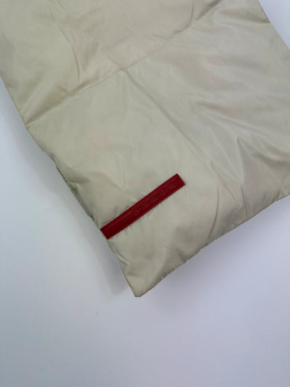 Prada beige puffer scarf with cream accents and magnetic closure, featuring signature logo.
