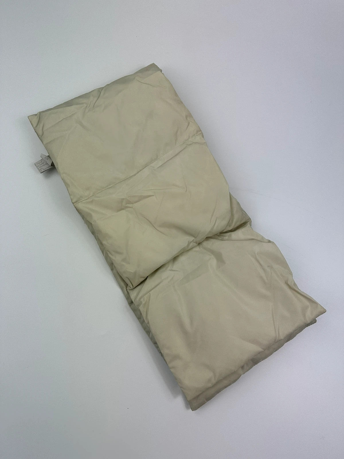 Prada beige puffer scarf with cream accents and magnetic closure, featuring signature logo.