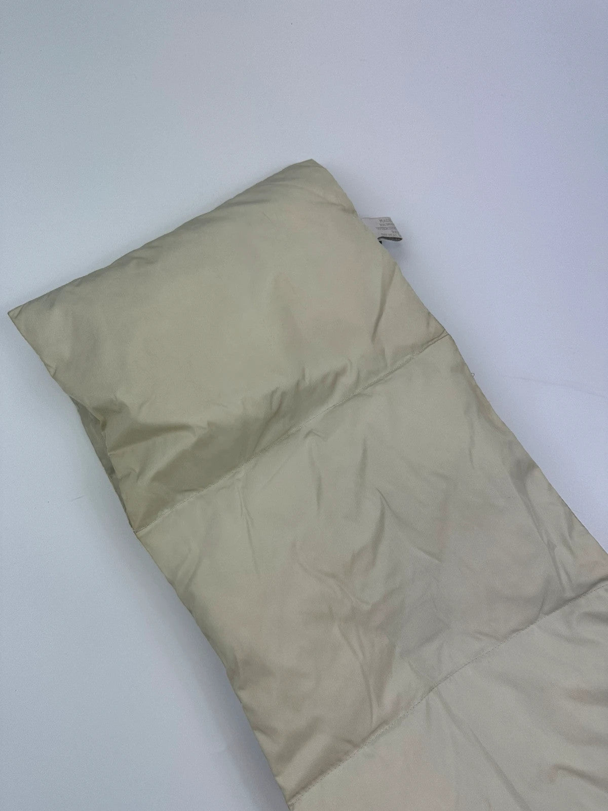 Prada beige puffer scarf with cream accents and magnetic closure, featuring signature logo.