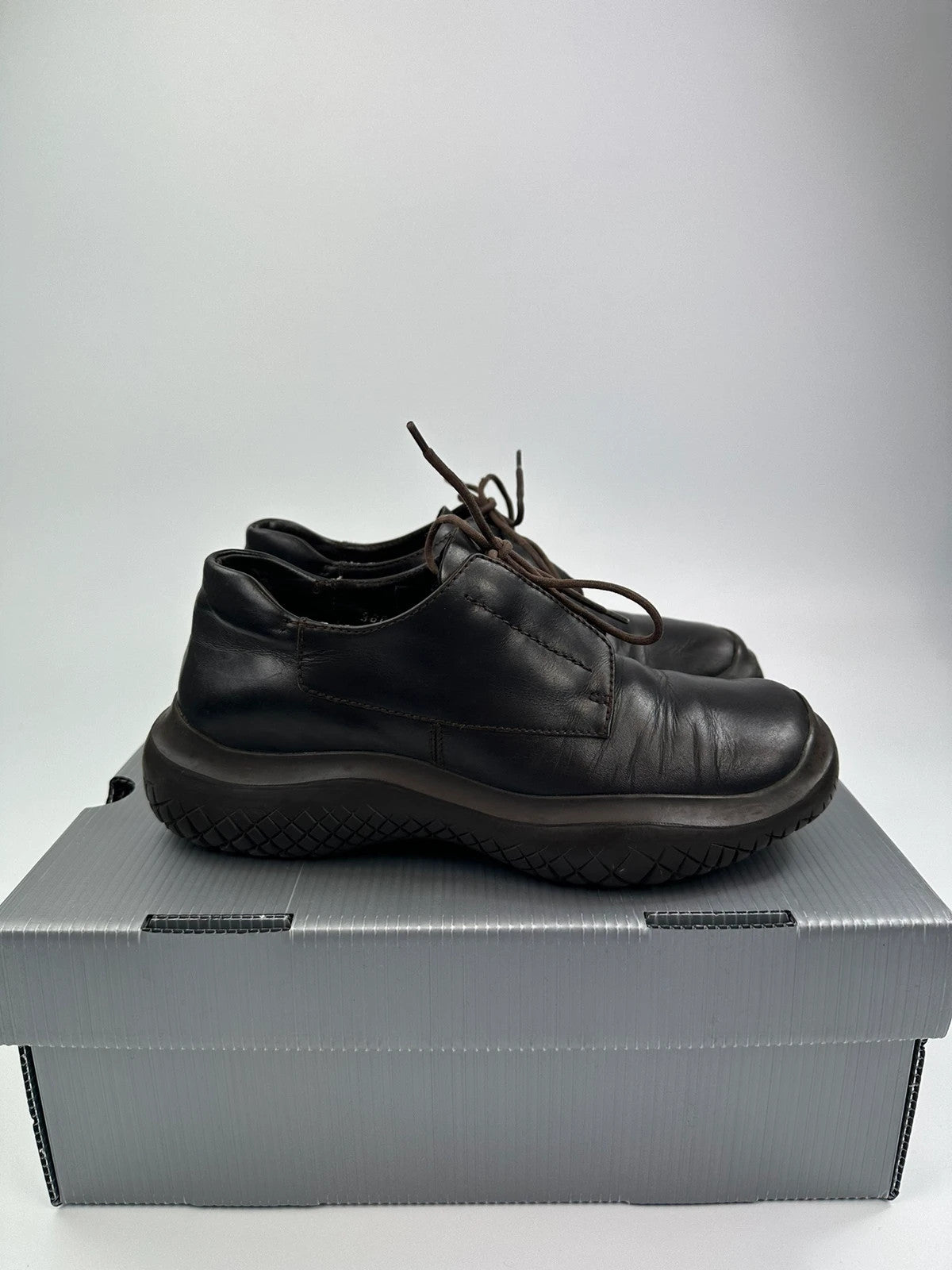 Prada black and brown leather loafer with Vibram puddle sole and moccasin design.