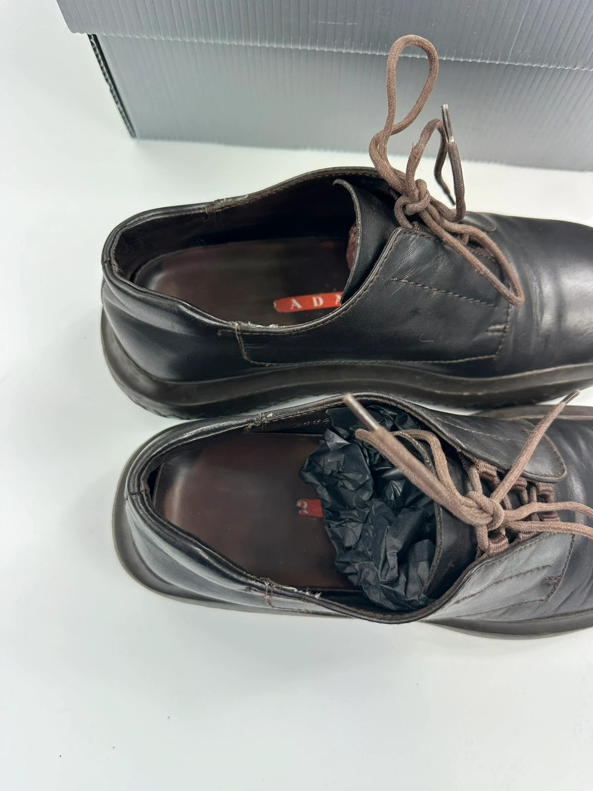 Prada black and brown leather loafer with Vibram puddle sole and moccasin design.