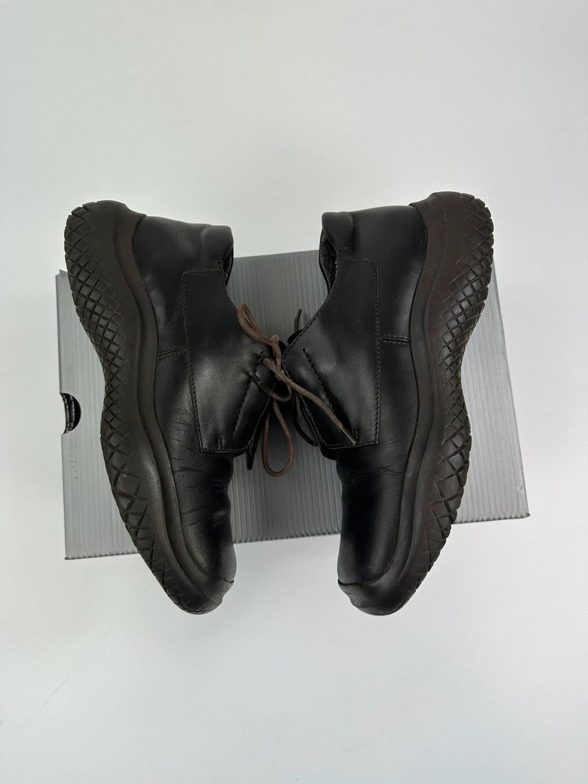 Prada black and brown leather loafer with Vibram puddle sole and moccasin design.