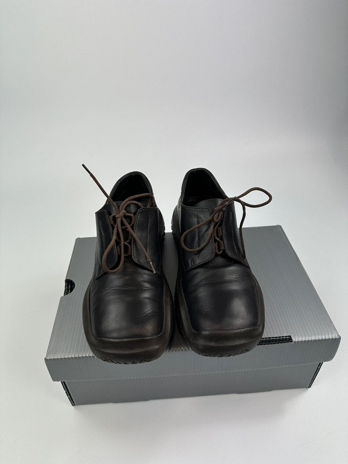 Prada black and brown leather loafer with Vibram puddle sole and moccasin design.