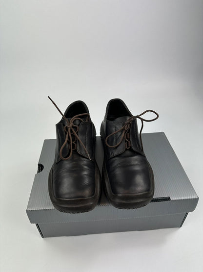 Prada black and brown leather loafer with Vibram puddle sole and moccasin design.
