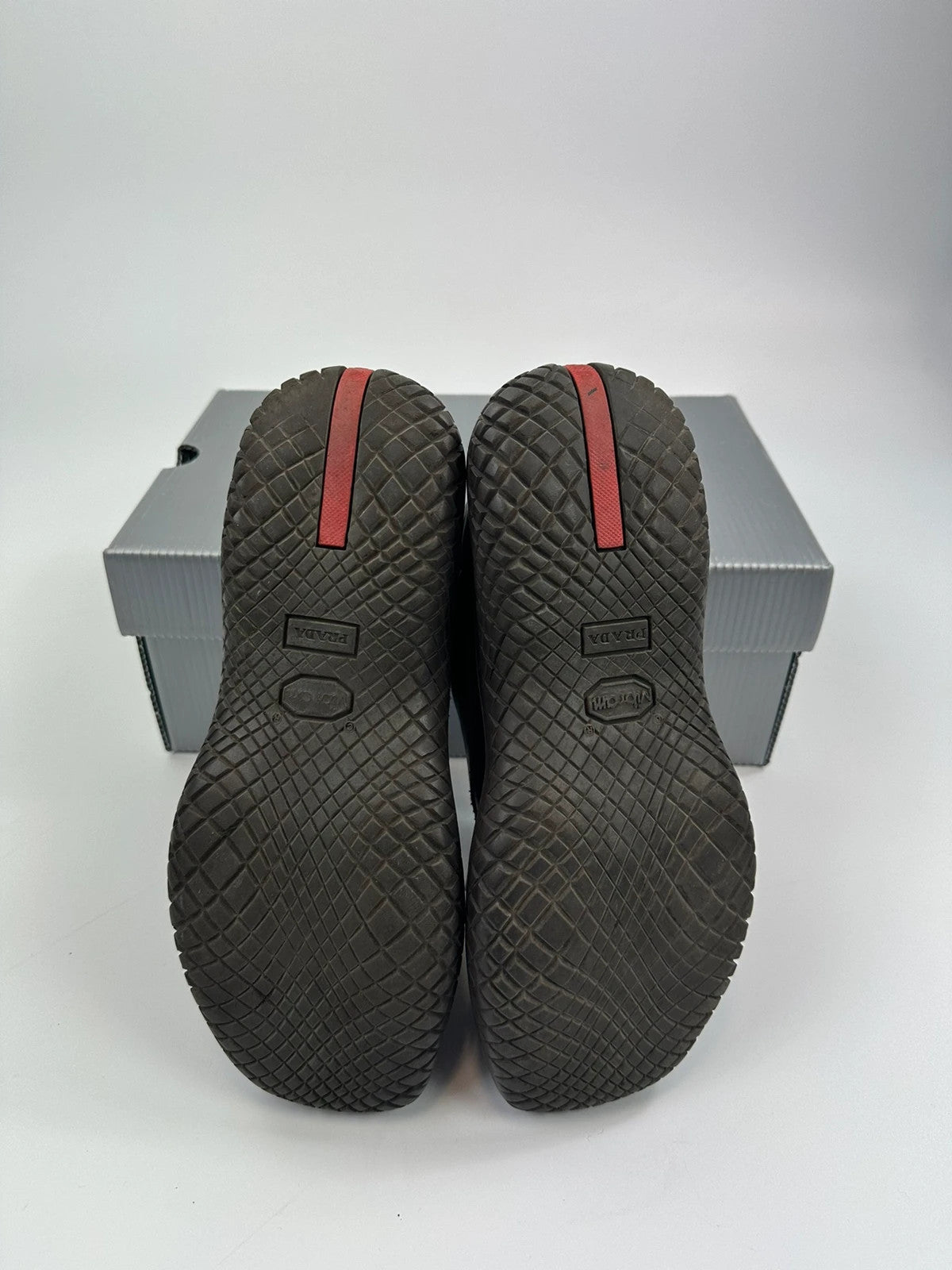 Prada black and brown leather loafer with Vibram puddle sole and moccasin design.