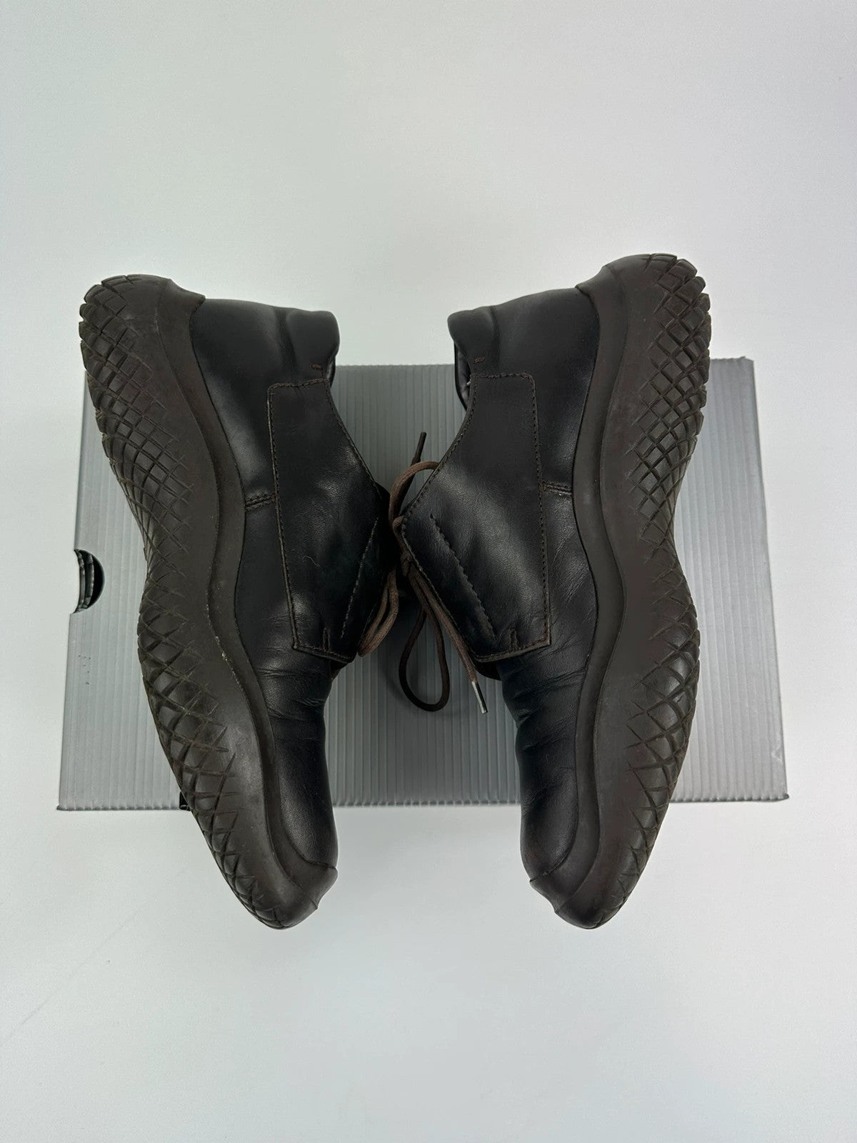 Prada black and brown leather loafer with Vibram puddle sole and moccasin design.