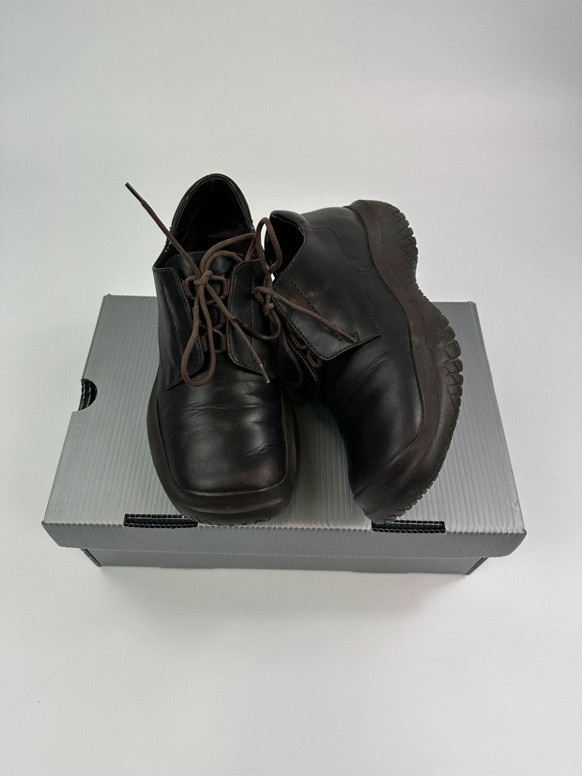 Prada black and brown leather loafer with Vibram puddle sole and moccasin design.