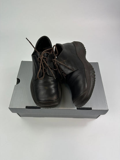 Prada black and brown leather loafer with Vibram puddle sole and moccasin design.