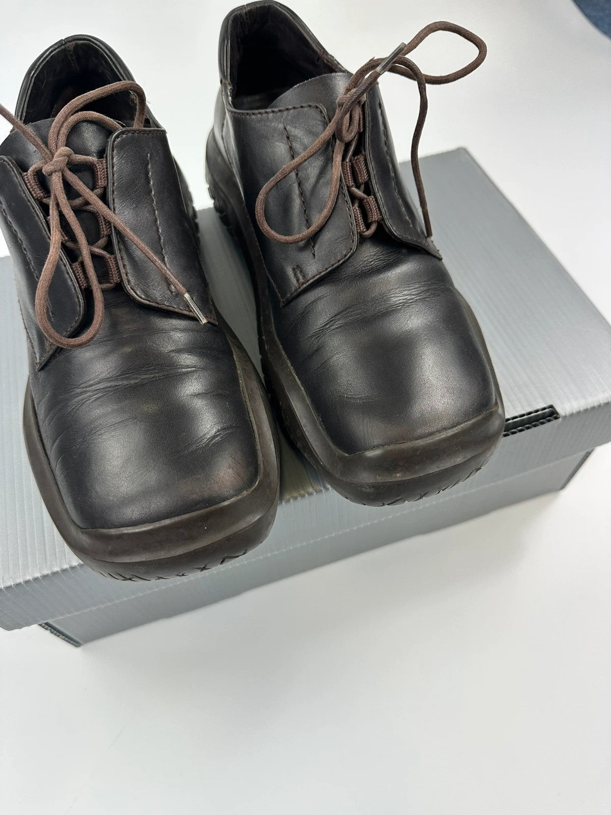 Prada black and brown leather loafer with Vibram puddle sole and moccasin design.