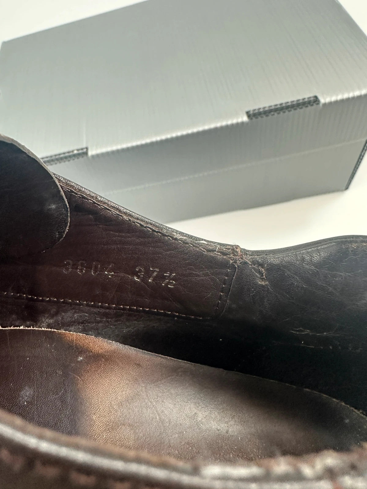 Prada black and brown leather loafer with Vibram puddle sole and moccasin design.
