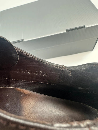 Prada black and brown leather loafer with Vibram puddle sole and moccasin design.