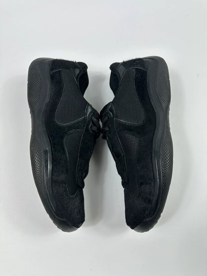 Prada black trainers with fur accents and mesh detailing, includes authenticity card.