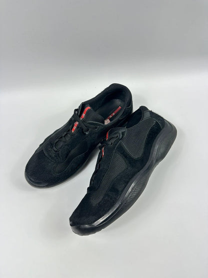 Prada black trainers with fur accents and mesh detailing, includes authenticity card.