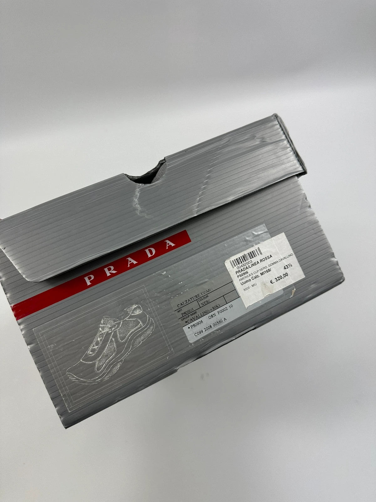 Prada black trainers with fur accents and mesh detailing, includes authenticity card.