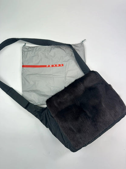 Prada black nylon crossbody bag with fur accents and linearossa logo.