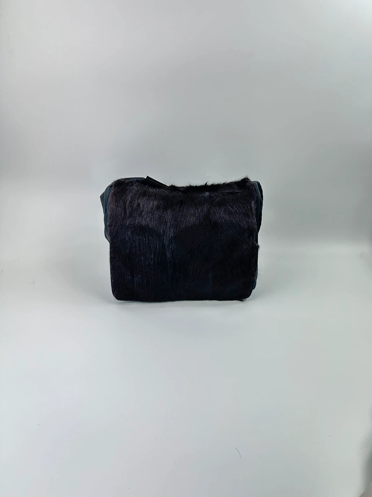 Prada black nylon crossbody bag with fur accents and linearossa logo.