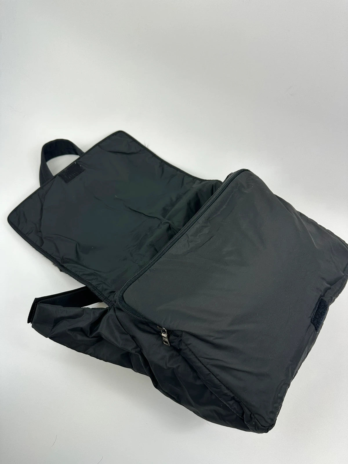 Prada black nylon crossbody bag with fur accents and linearossa logo.