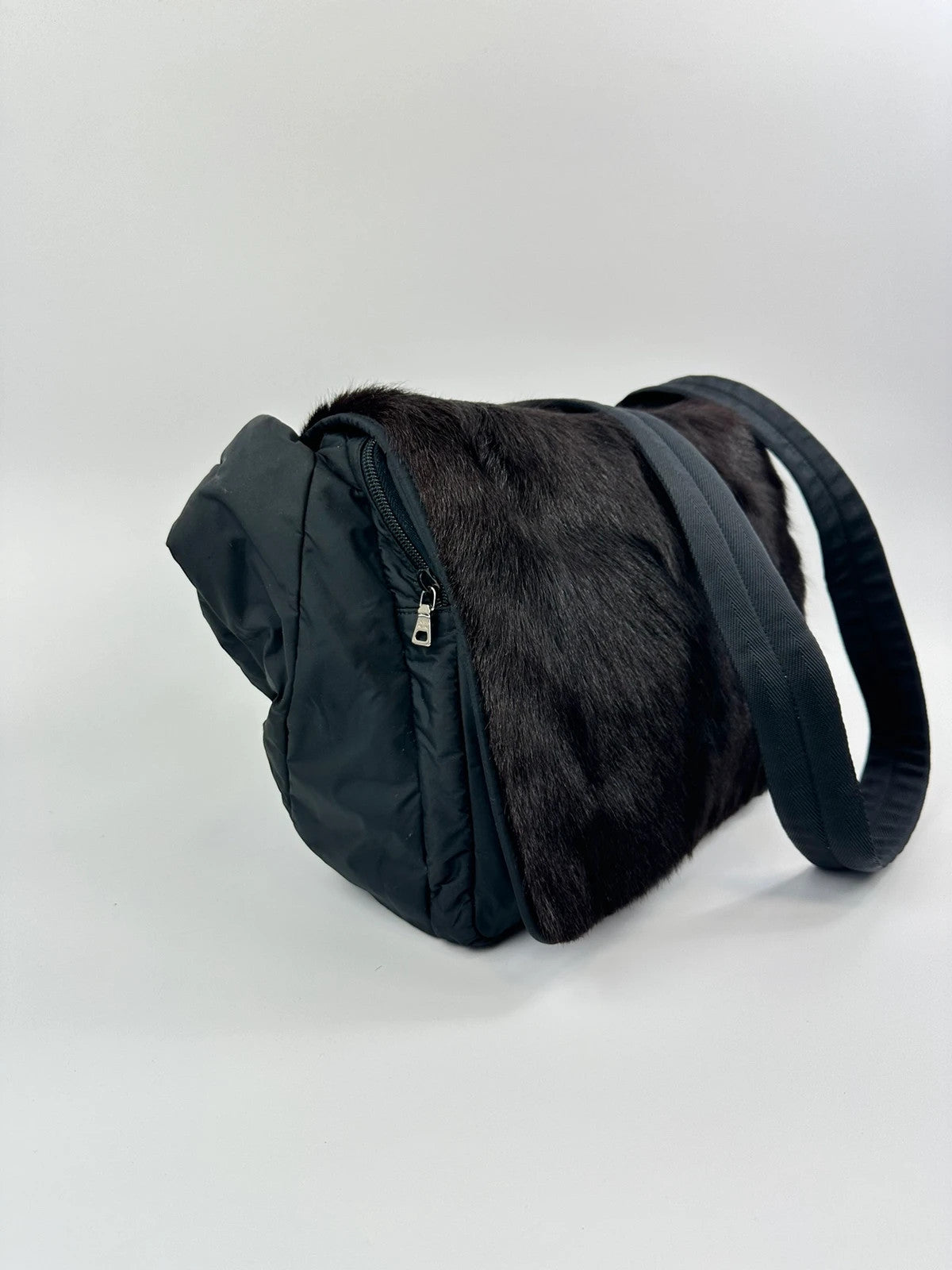 Prada black nylon crossbody bag with fur accents and linearossa logo.