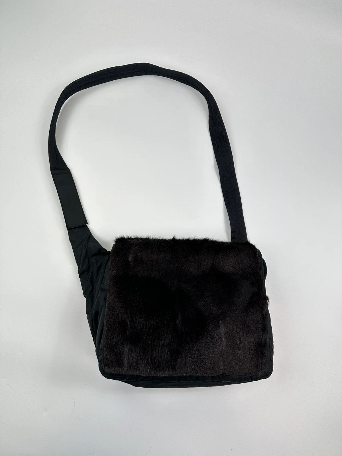 Prada black nylon crossbody bag with fur accents and linearossa logo.