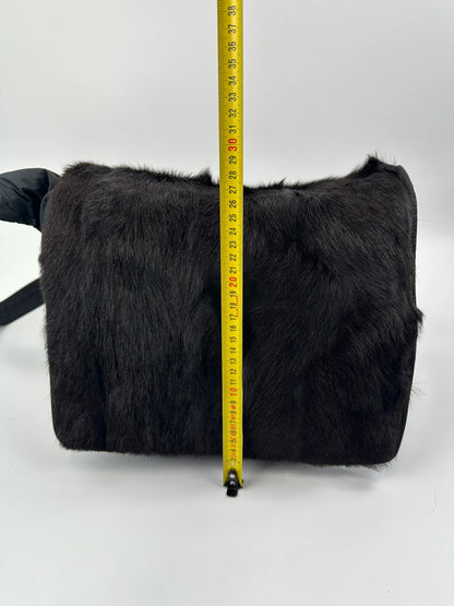 Prada black nylon crossbody bag with fur accents and linearossa logo.