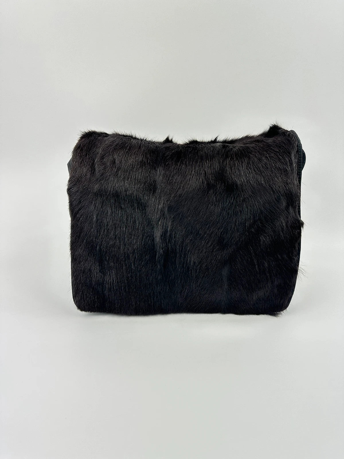 Prada black nylon crossbody bag with fur accents and linearossa logo.