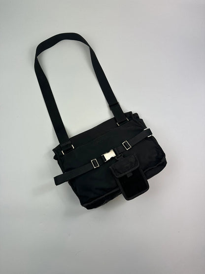 Prada black and grey mesh crossbody waist bag with logo and dual compartment design.