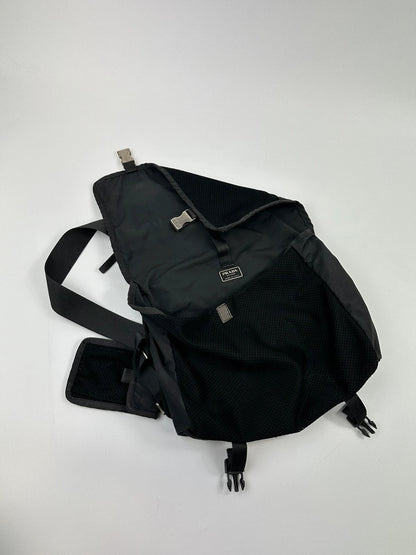 Prada black and grey mesh crossbody waist bag with logo and dual compartment design.