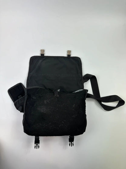 Prada black and grey mesh crossbody waist bag with logo and dual compartment design.