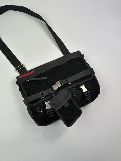 Prada black and grey mesh crossbody waist bag with logo and dual compartment design.