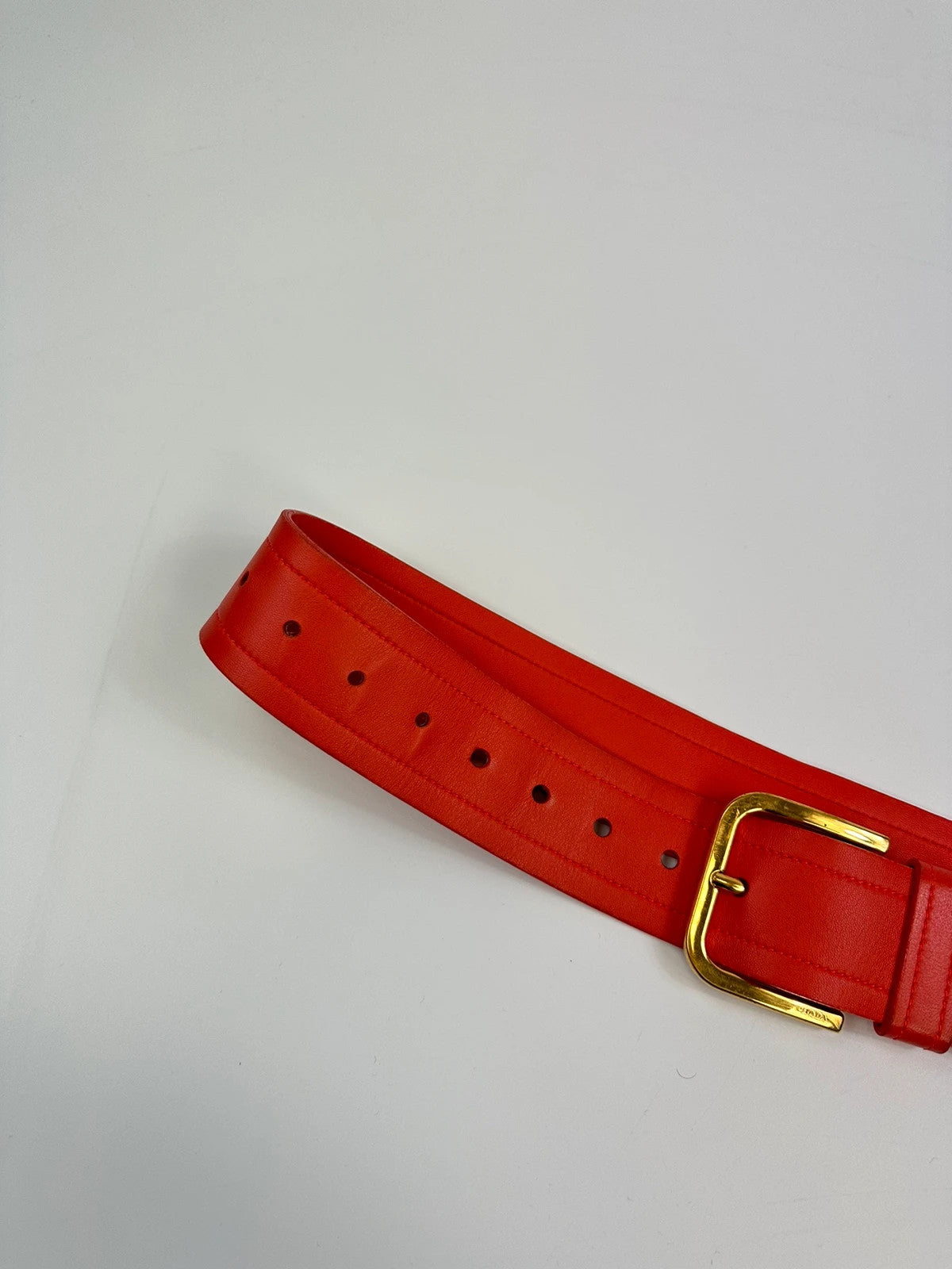 Prada burgundy leather belt with large rose gold buckle, vintage 2010 collection.