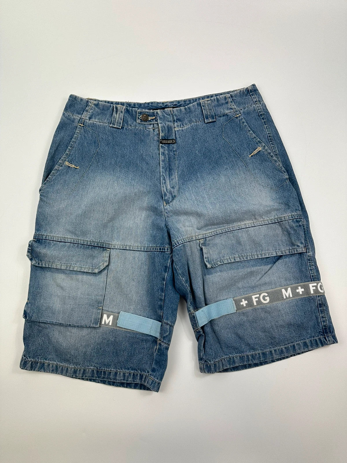 Marithé Francois Girbaud blue baggy denim shorts with cargo pockets and adjustable scratch detail.