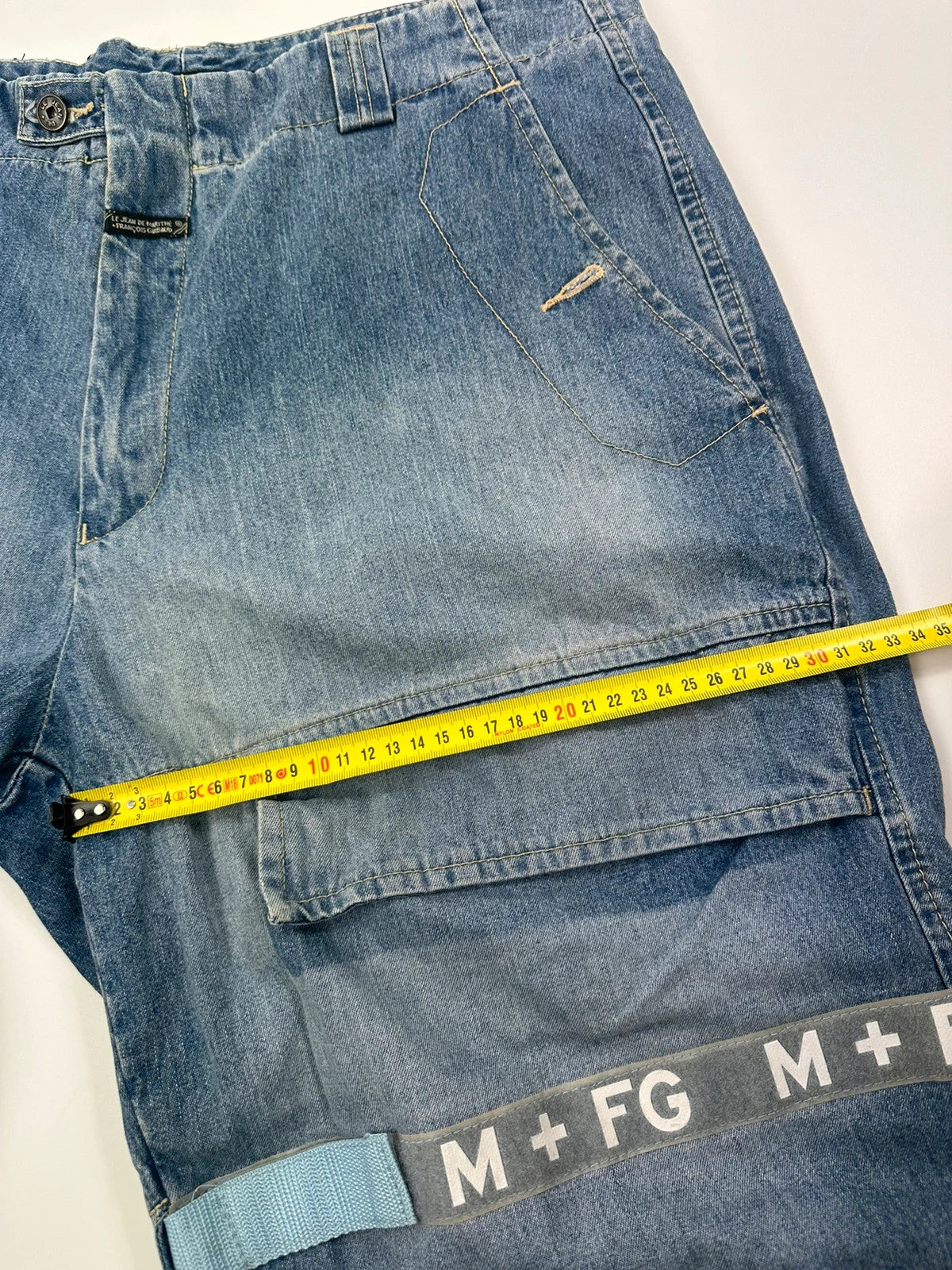 Marithé Francois Girbaud blue baggy denim shorts with cargo pockets and adjustable scratch detail.
