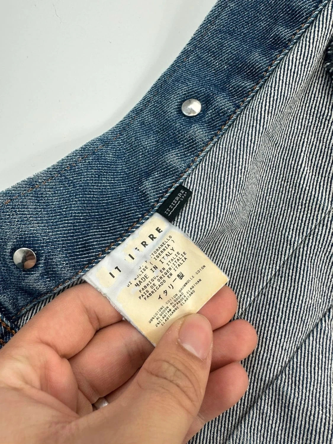 Dolce & Gabbana blue boxy crop denim jacket with logo detail and distressed finish.