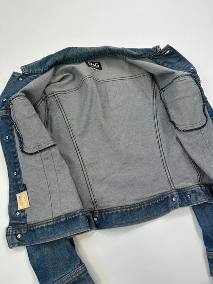 Dolce & Gabbana blue boxy crop denim jacket with logo detail and distressed finish.