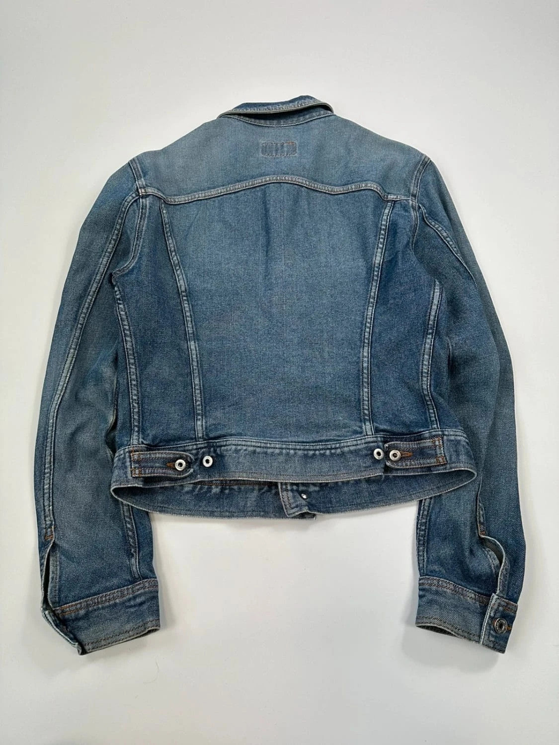 Dolce & Gabbana blue boxy crop denim jacket with logo detail and distressed finish.