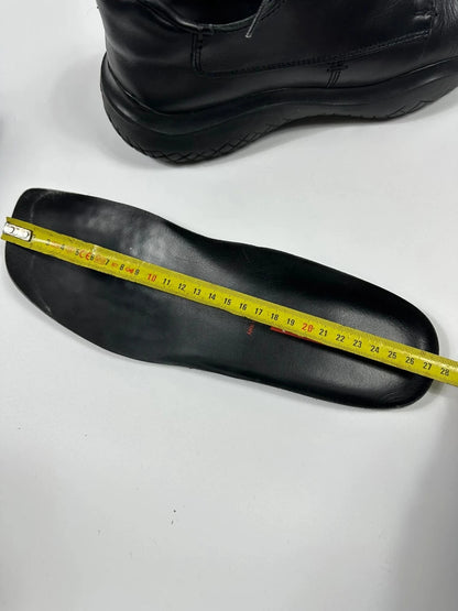 Prada black leather loafer with Vibram sole, sleek futuristic design from FW1999 collection.