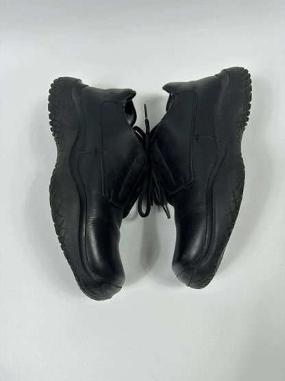 Prada black leather loafer with Vibram sole, sleek futuristic design from FW1999 collection.