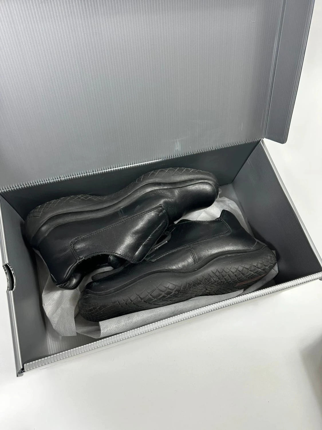 Prada black leather loafer with Vibram sole, sleek futuristic design from FW1999 collection.