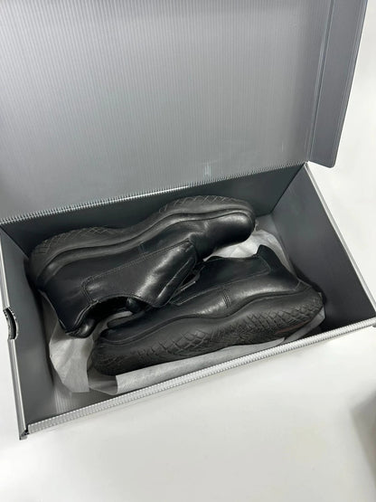 Prada black leather loafer with Vibram sole, sleek futuristic design from FW1999 collection.