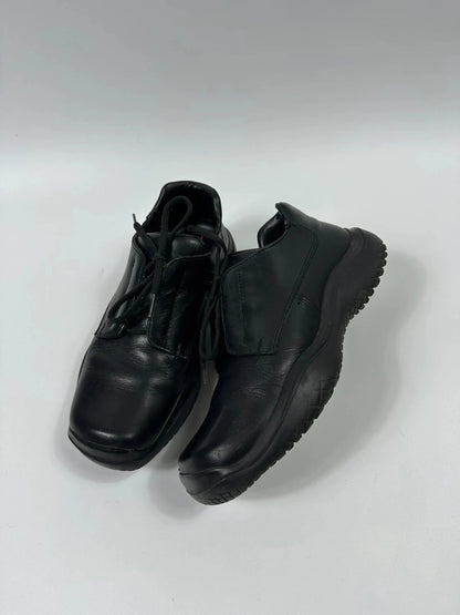 Prada black leather loafer with Vibram sole, sleek futuristic design from FW1999 collection.