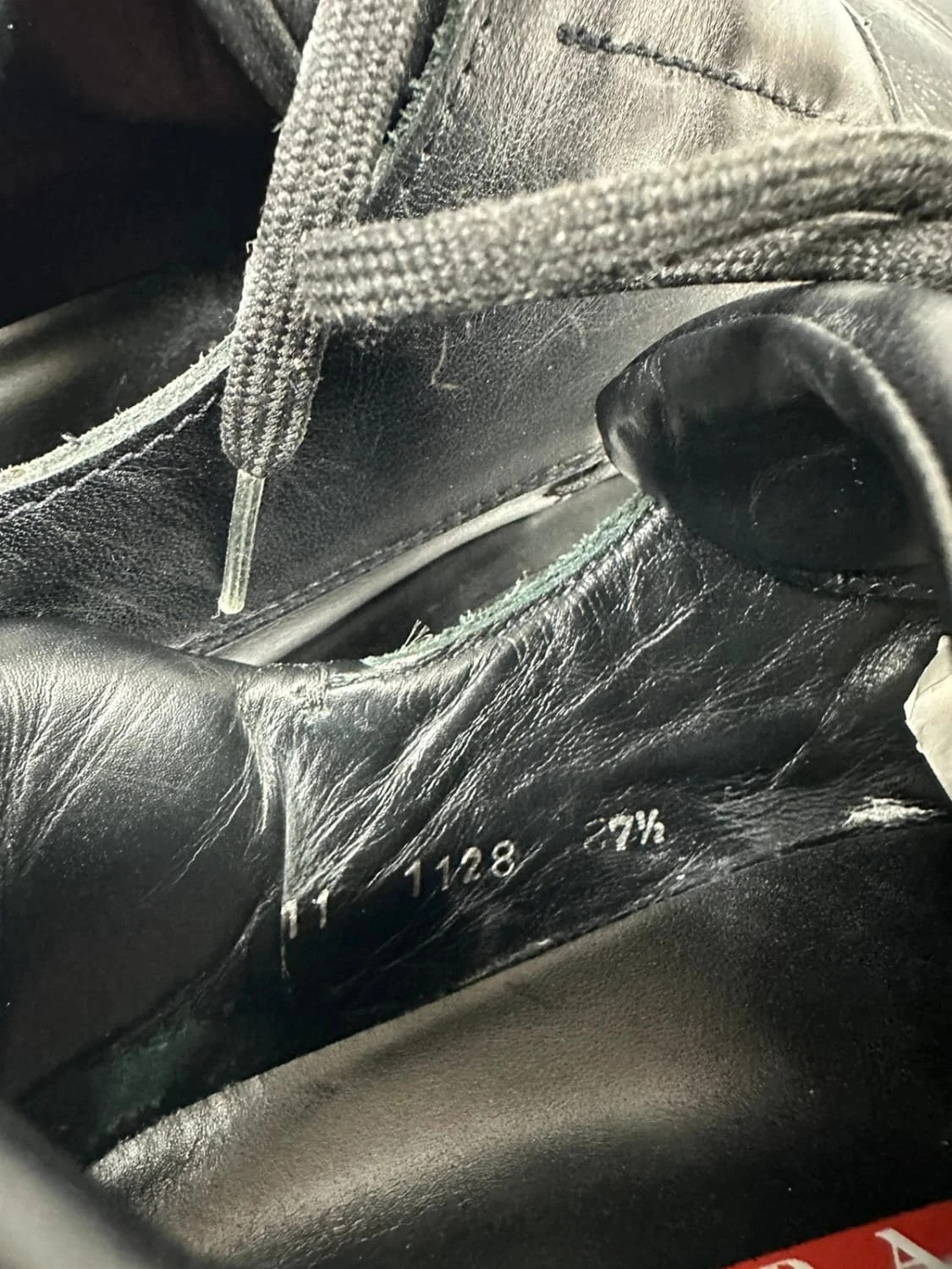 Prada black leather loafer with Vibram sole, sleek futuristic design from FW1999 collection.