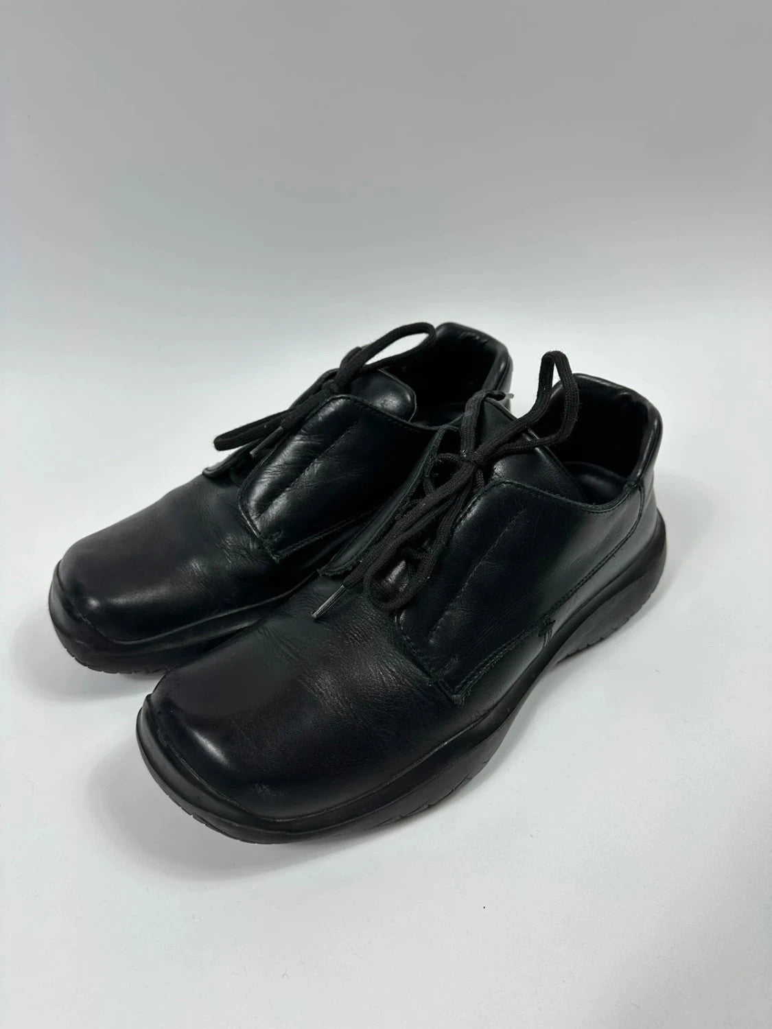 Prada black leather loafer with Vibram sole, sleek futuristic design from FW1999 collection.