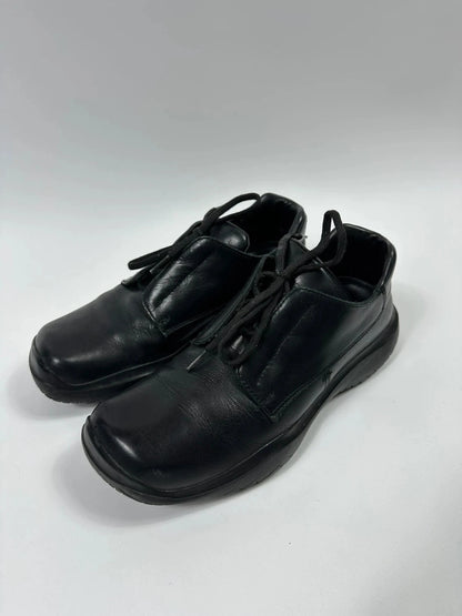 Prada black leather loafer with Vibram sole, sleek futuristic design from FW1999 collection.