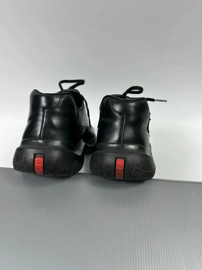 Prada black leather loafer with Vibram sole, sleek futuristic design from FW1999 collection.