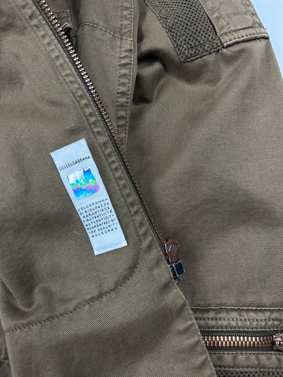 Dolce & Gabbana khaki crop jacket with army mesh pockets and logo detail.